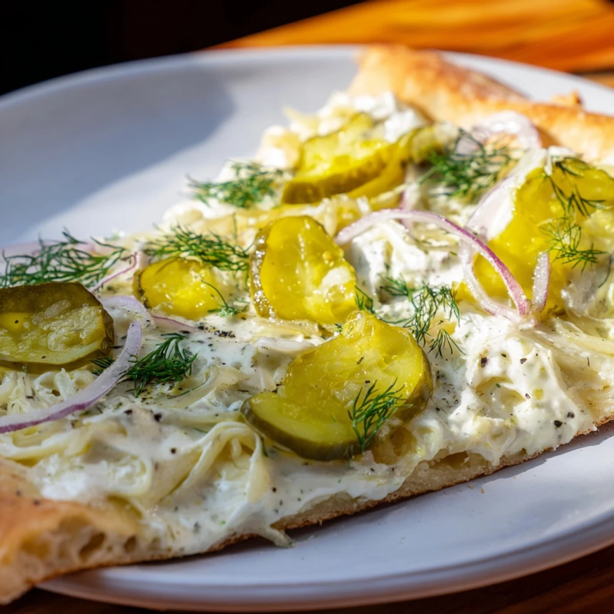 Tangy pickle pizza topped with creamy sauce, mozzarella, and crunchy dill pickles.