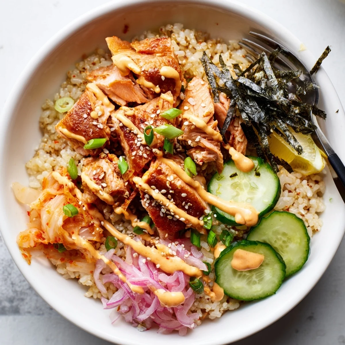 Flavorful crispy salmon over golden rice, topped with spicy mayo and fresh veggies.  