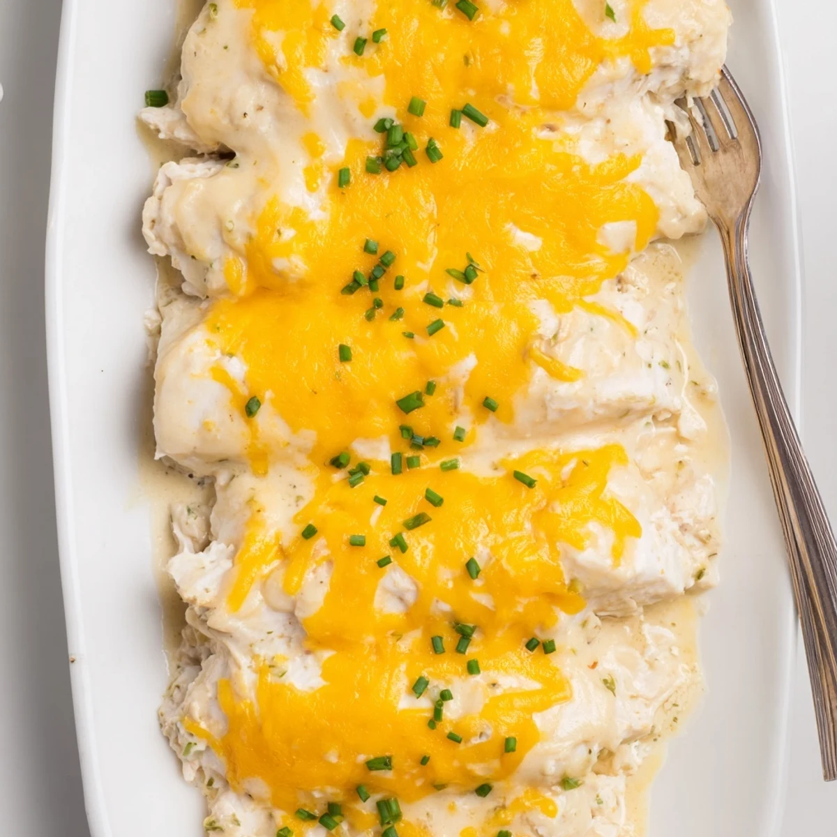 Golden-baked Cheddar Ranch Chicken Bake garnished with fresh chives, creamy and delicious.