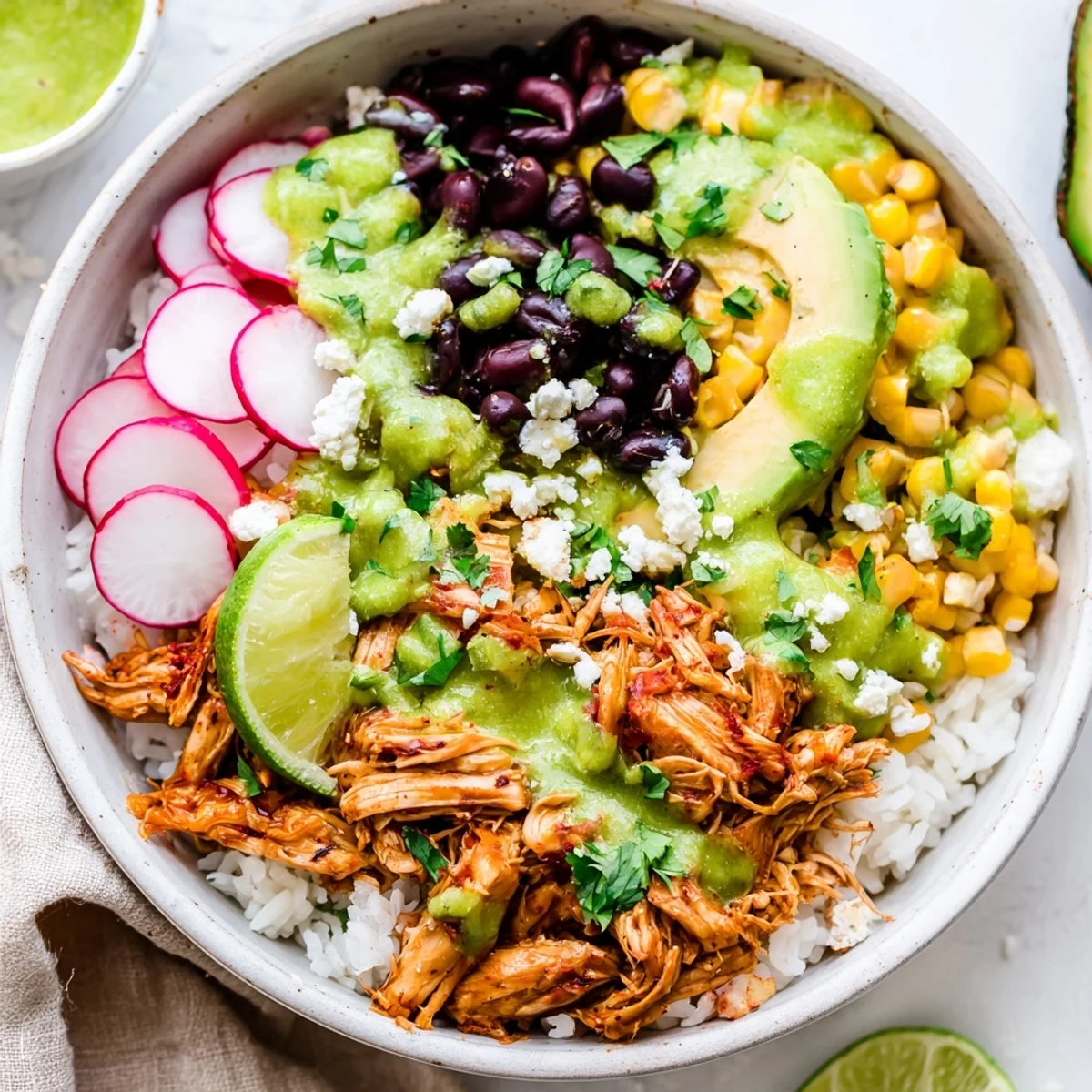 Savory Green Enchiladas Rice Bowl filled with chicken, black beans, and fluffy rice.