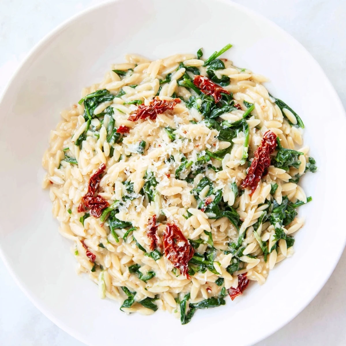 Imagine a vibrant bowl of Creamy Tuscan Orzo Bowl with a garlic-infused, rich sauce.