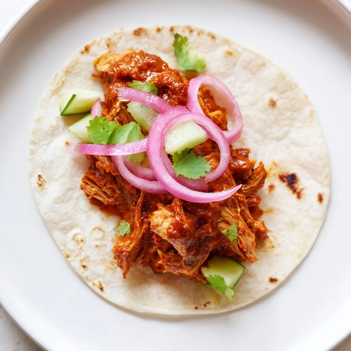 Close-up of delicious chicken tikka masala tacos, showing the tender chicken and spicy, flavorful sauce.