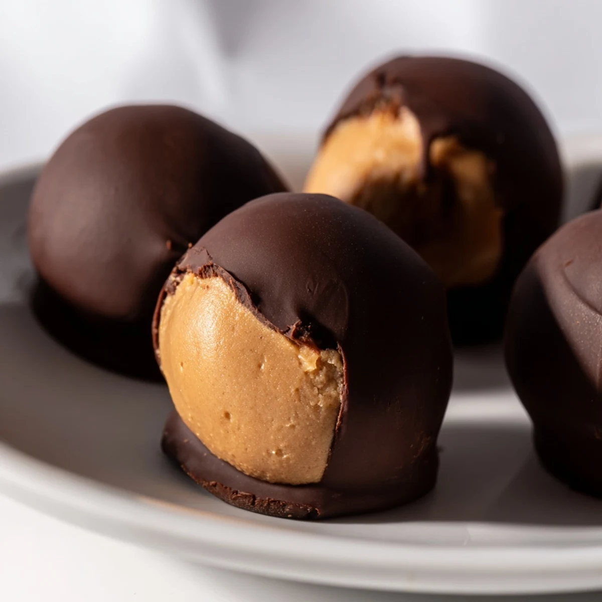 Indulge in these homemade Peanut Butter Buckeyes; a delicious sweet treat perfect for holiday gatherings.