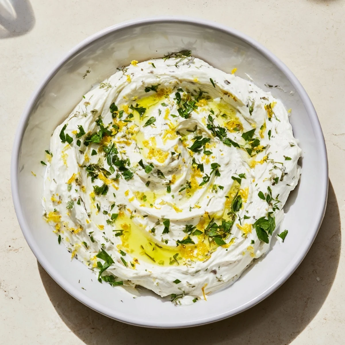 Smooth, creamy whipped feta, beautifully garnished, ready to scoop with crunchy pita chips.