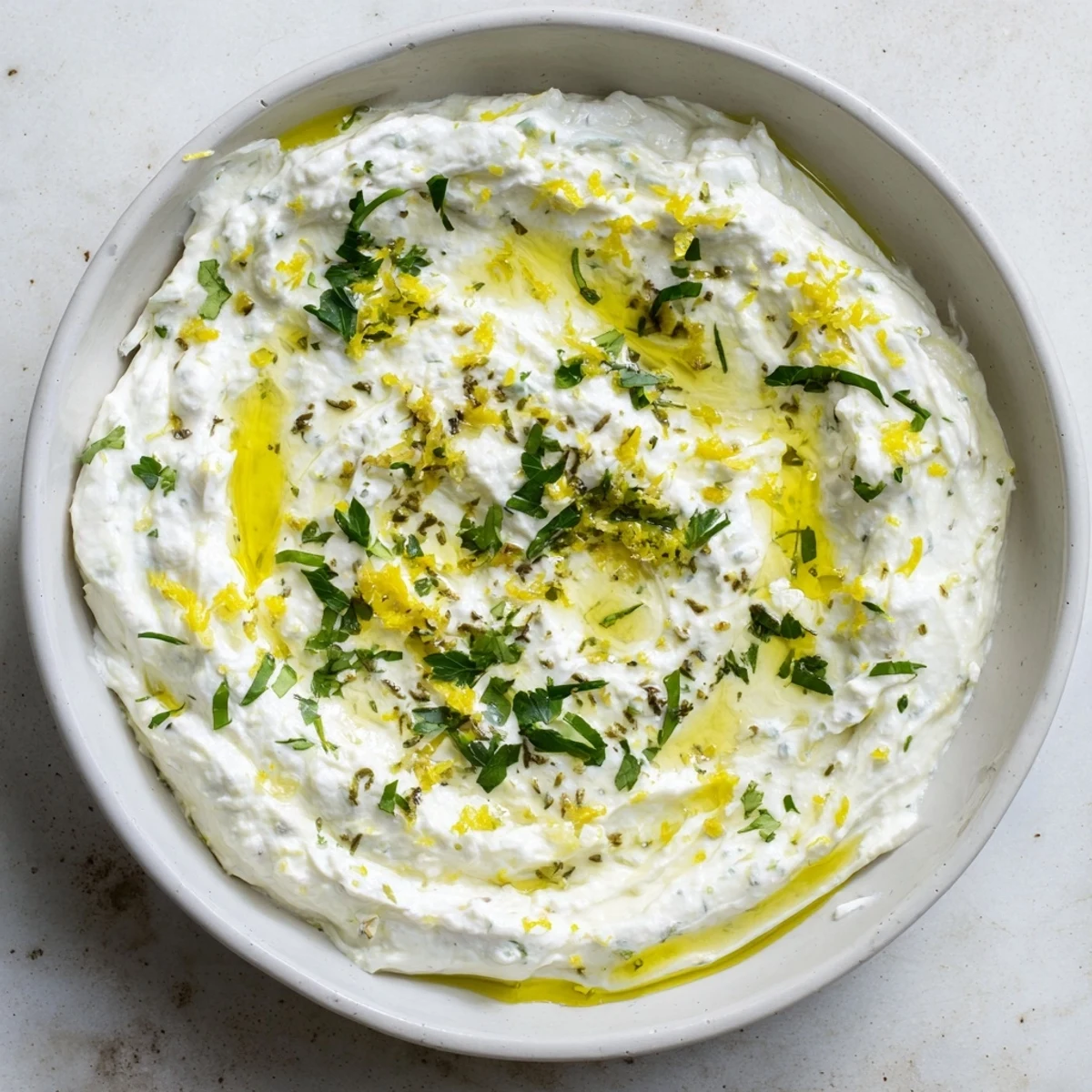 Vibrant image of whipped feta with Greek seasoning, perfect appetizer for sharing at a party.