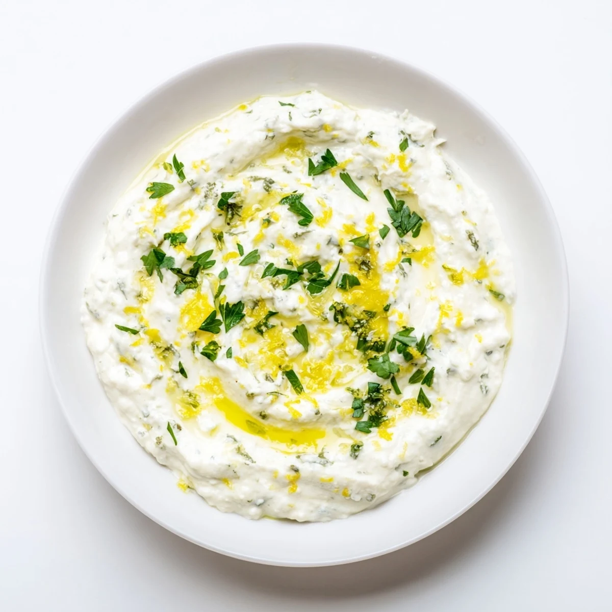 A luscious bowl of whipped feta, drizzled with olive oil, inviting you to dip and enjoy.