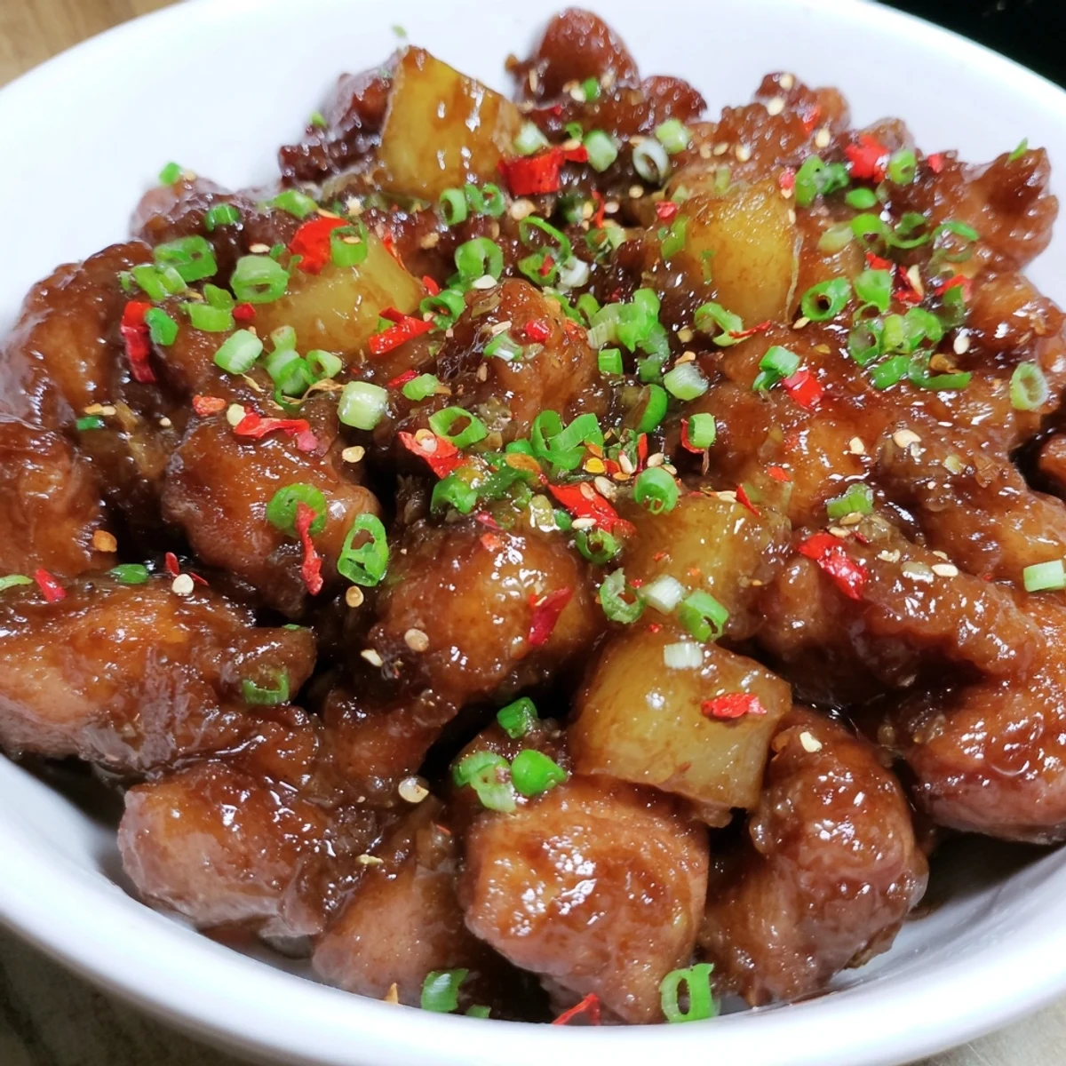 Juicy Brown Sugar Pineapple Chicken, glazed and glistening, with visible pineapple chunks.