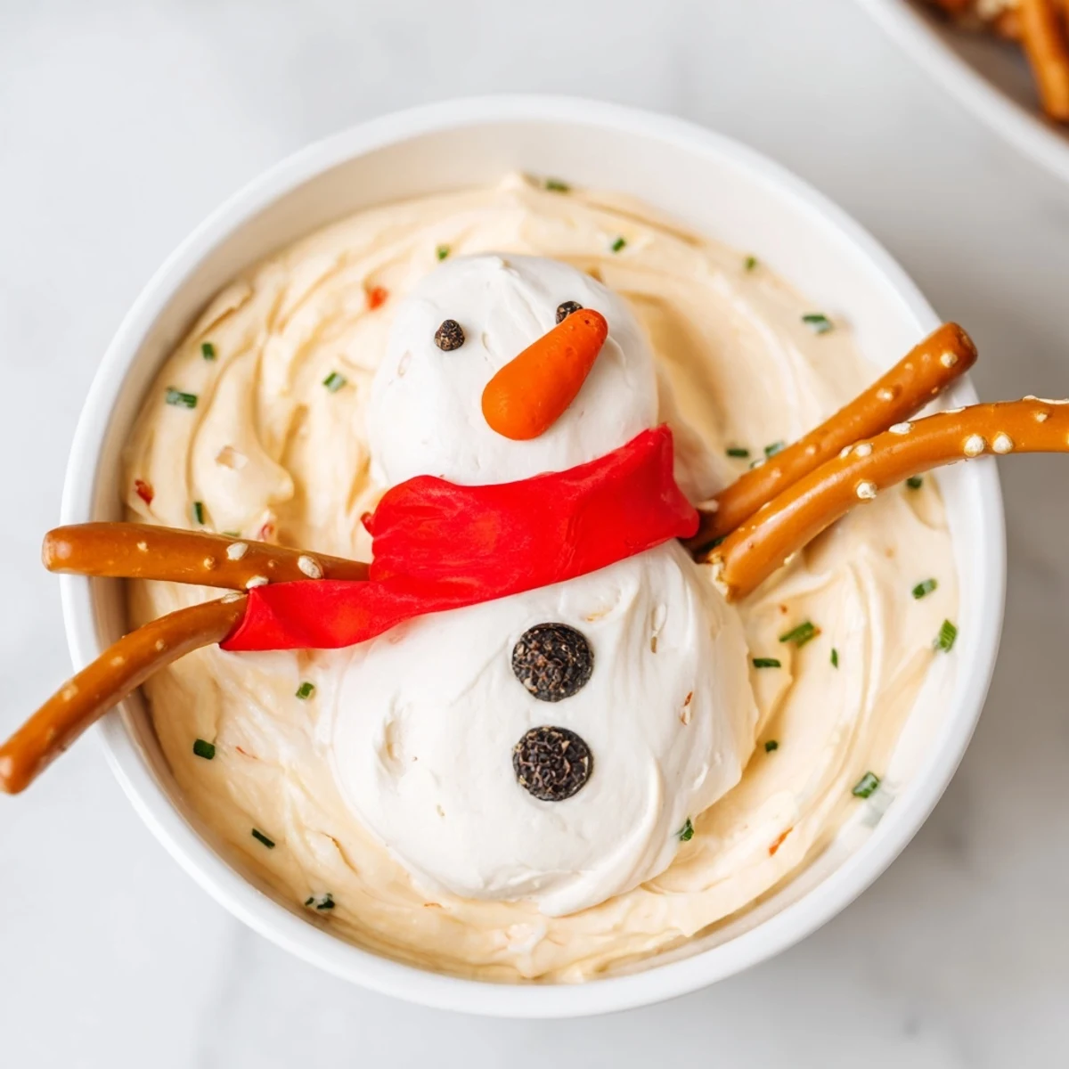Bright red bell pepper scarves adorn our delicious Melted Snowman Dip, perfect for sharing.