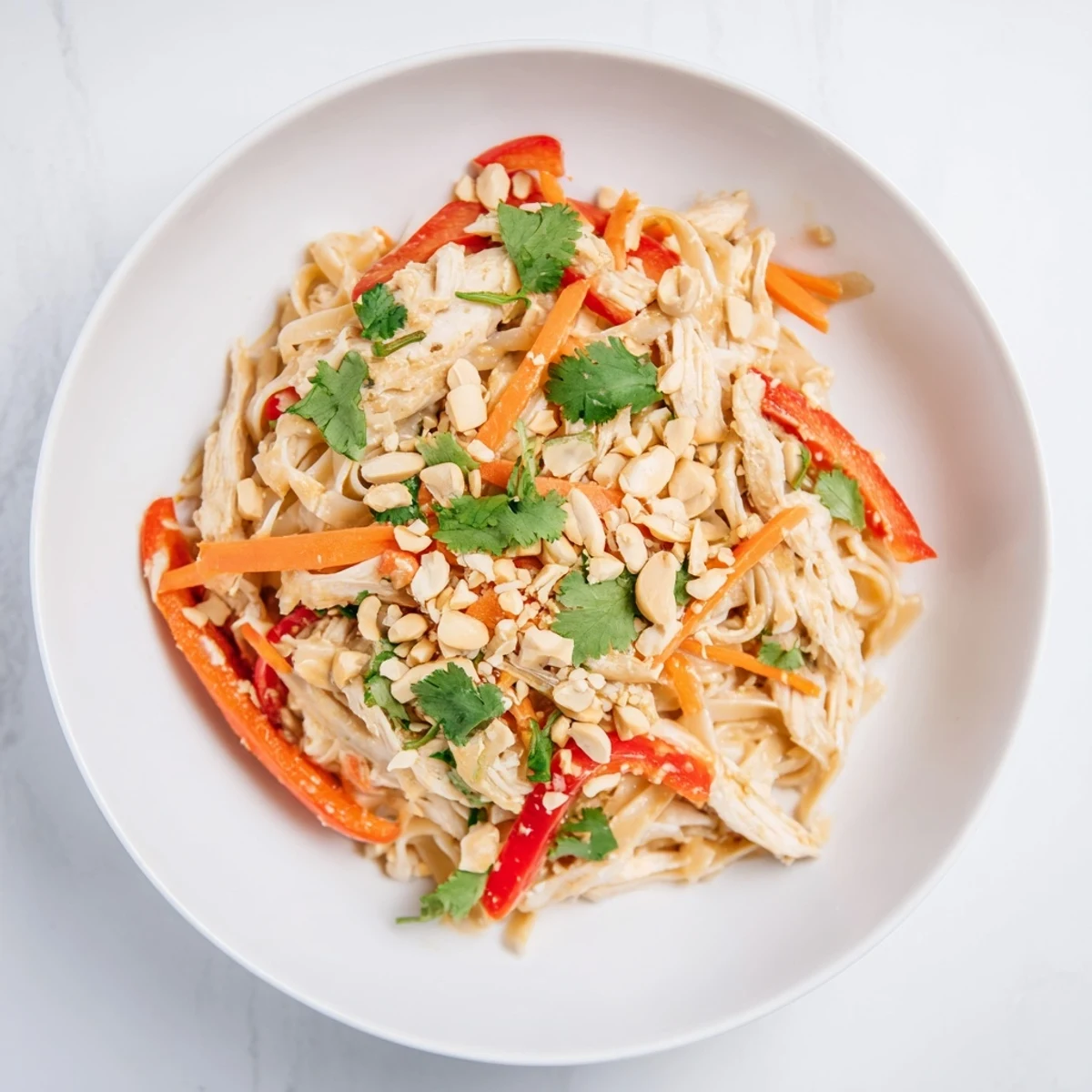 Fresh, vibrant Thai-Inspired Peanut Chicken Pasta salad showcasing the tender chicken and crunchy toppings.