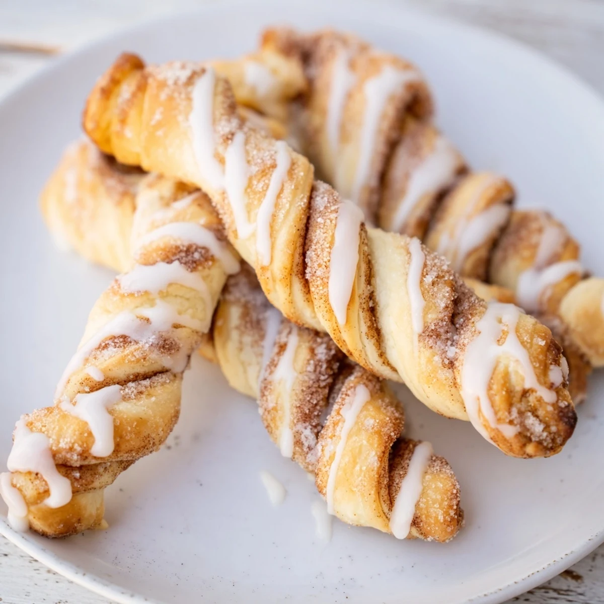 Close-up of freshly baked air-fryer cinnamon roll twists dusted with cinnamon sugar, perfect for breakfast.
