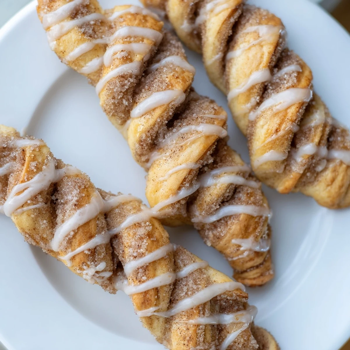 Homemade air-fryer cinnamon roll twists, ready to eat, exuding warmth and the sweet aroma of cinnamon.