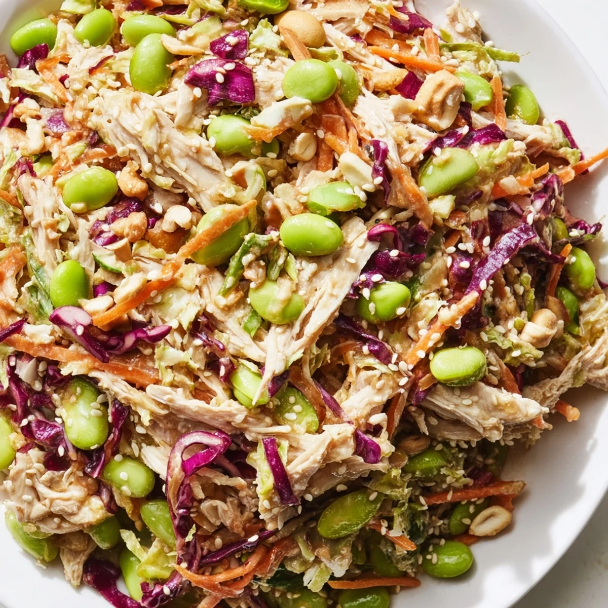 Healthy Edamame Crunch Chicken Salad with bell peppers and green onions, drizzled with a spicy ginger-lime dressing for lunch.