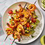 A vibrant Easy Grilled Shrimp Bowl showcases seasoned shrimp, creamy avocado salsa, and fresh corn for a quick meal.