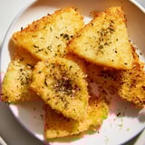 A plate of hot, golden fried Greek Saganaki cheese sprinkled with oregano, ready to serve and savor.