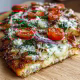 Golden, crispy-edged Crispy Garlic Parmesan Naan Pizza fresh from the oven, topped with melted mozzarella, bright cherry tomatoes, and fresh spinach leaves. 