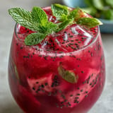Refreshing Dragon Fruit Lemonade with Chia Seeds, garnished with mint and lemon.