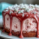 Stunning pink rosé velvet cake, frosted, with a shimmering gold chocolate drip.