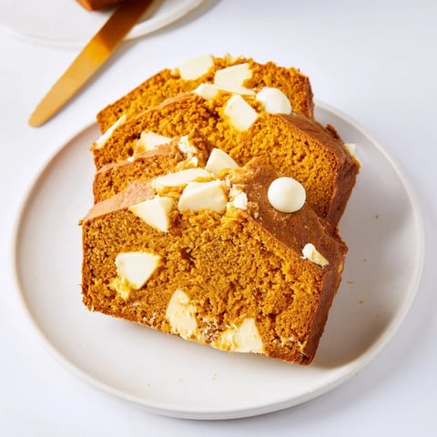 Moist Pumpkin White Chocolate Muffin Loaf with melty chips, perfect for breakfast delight.  