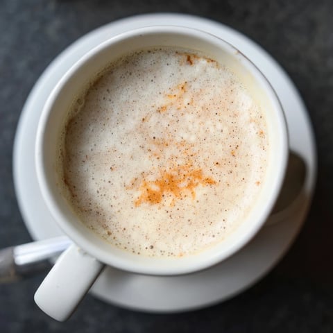Homemade low-cost spiced chai latte in a cozy mug, fragrant and warming.  