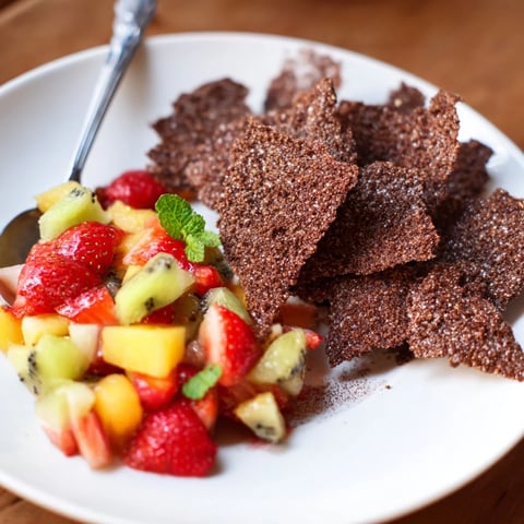 Crispy chocolate tortilla chips served with fresh, colorful fruit salsa delightfully.  