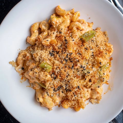 Bold Spicy Kimchi Mac & Cheese topped with crunchy sesame breadcrumbs, perfect for comfort food lovers.  