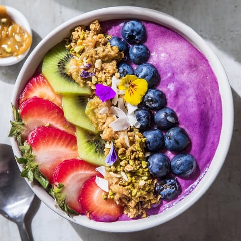 Colorful Vibrant Smoothie Bowls topped with fresh fruit and crunchy toppings.