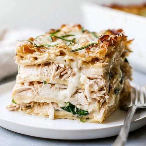 Savory rosemary chicken lasagna layered with creamy béchamel and bubbling mozzarella.  