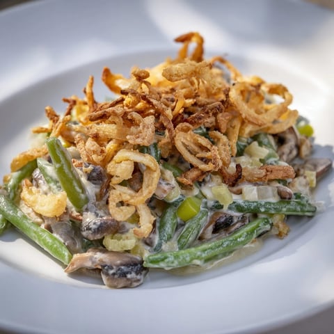 A nostalgic Old-School Green Bean Casserole topped with crispy fried onions and creamy sauce.