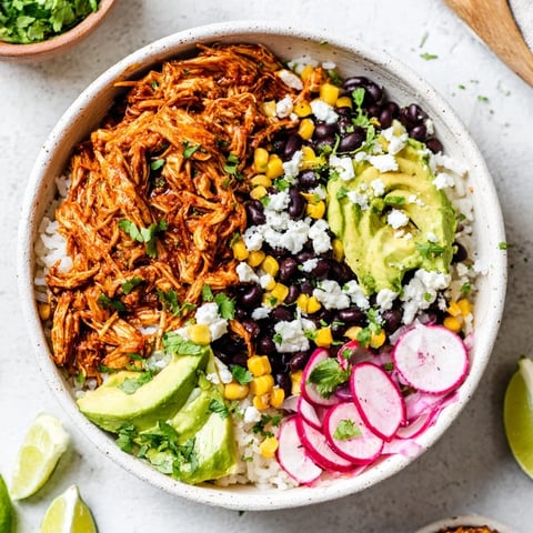 A colorful Green Enchiladas Rice Bowl topped with fresh avocado and cilantro.  