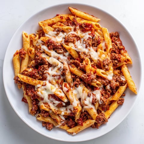 Steaming, golden Cheesy Beef & Penne Bake with bubbly cheese, a rich tomato sauce, and perfectly cooked pasta.