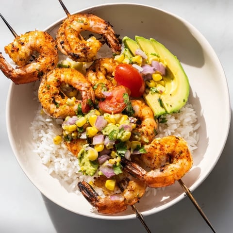 Juicy grilled shrimp nestled atop rice with colorful avocado corn salsa, this Easy Grilled Shrimp Bowl is perfect.