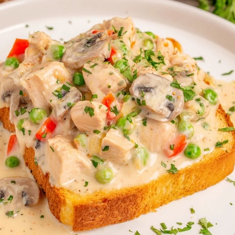 Creamy Chicken à la King over buttered toast, a comforting classic with savory flavors and textures.