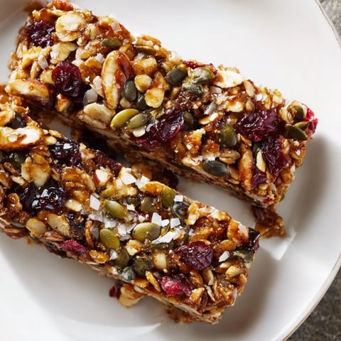 Golden-brown Roasted Pumpkin Seed & Cranberry Granola Bars, offering a perfect balance of sweet and chewy textures.