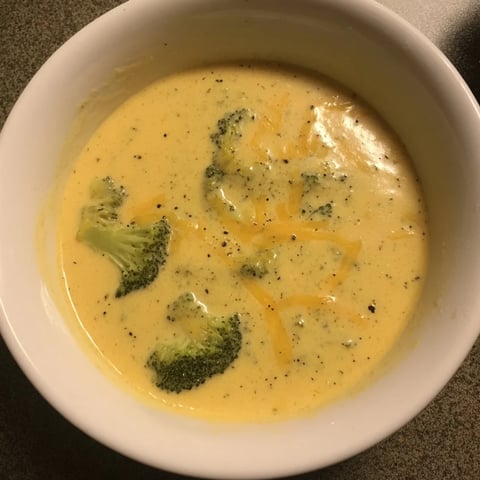 Steaming bowl of creamy Broccoli Cheese Soup, a comforting classic with melted cheddar and fresh broccoli.