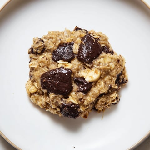 Golden, chewy oat-banana chocolate chip cookies freshly baked and ready to eat, a treat.