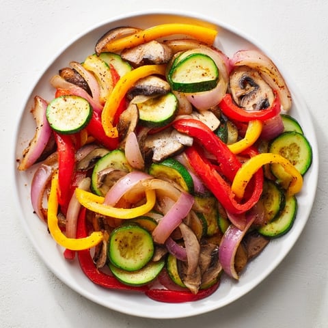 Vibrant veggie skillet fajitas sizzling in a cast-iron pan, perfect for a quick and flavorful Tex-Mex dinner.