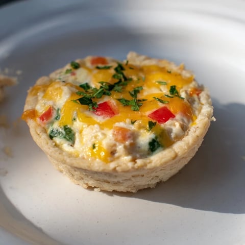 Golden-brown, savory Easy Festive Mini Quiche Cups, baked in muffin tins, ready for brunch.