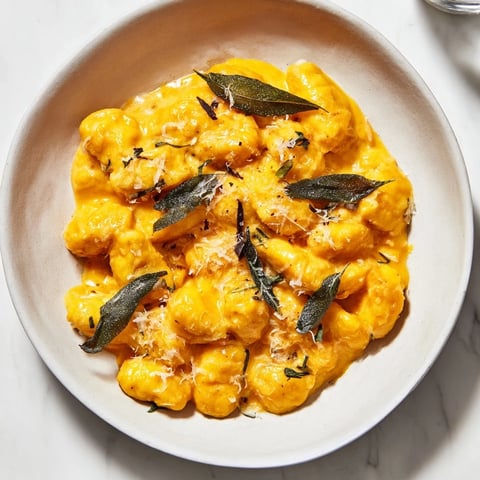 Creamy pumpkin sage gnocchi pasta, warm and inviting, topped with crispy sage and Parmesan.