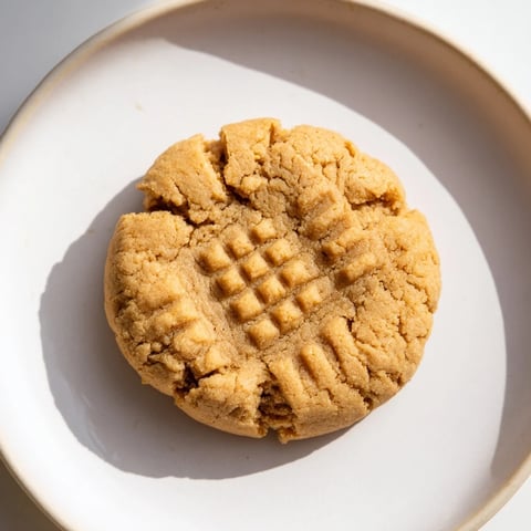 Golden-brown Flourless Peanut Butter Cookies, neatly arranged on a baking sheet, ready to cool.
