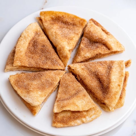 Golden brown cinnamon sugar tortilla chips, a sweet and crispy dessert snack freshly made.