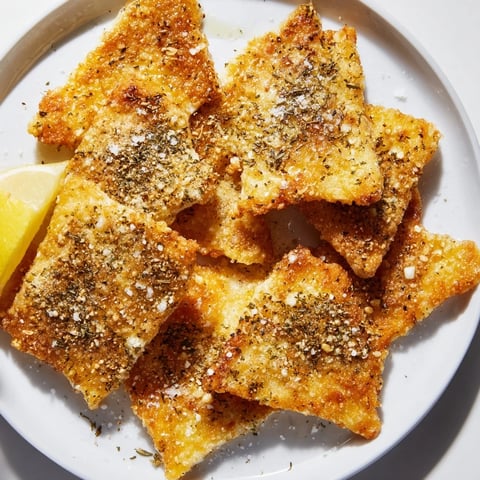 Golden, crispy Greek Saganaki cheese appetizer, fried and sizzling, ready to enjoy with lemon wedges.