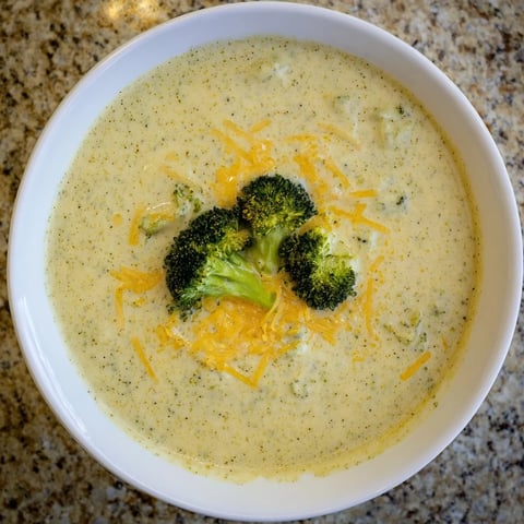Creamy Broccoli Cheddar Soup, garnished with roasted broccoli, perfect for a cozy dinner.