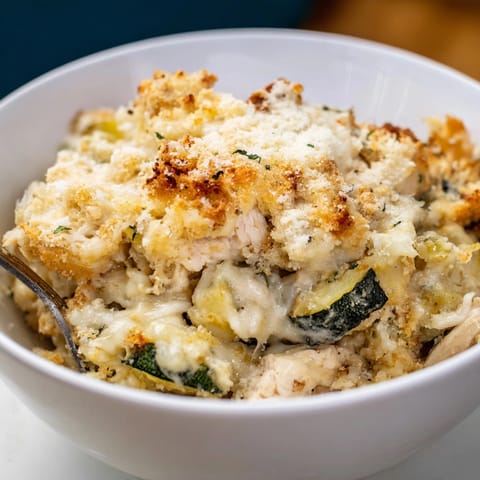 Creamy Alfredo Chicken Zucchini Casserole: Layers of cheesy goodness, chicken, zucchini, ready to serve.
