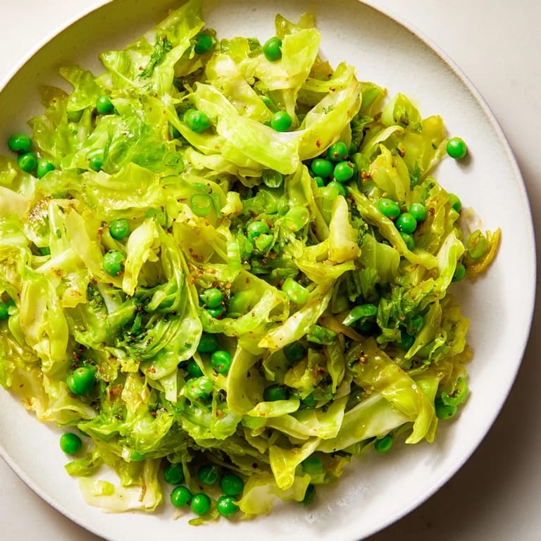 Steaming Cabbage Stir-Fry with Garlic, Soy, and Peas, a delicious and quick Asian-inspired vegetarian meal.