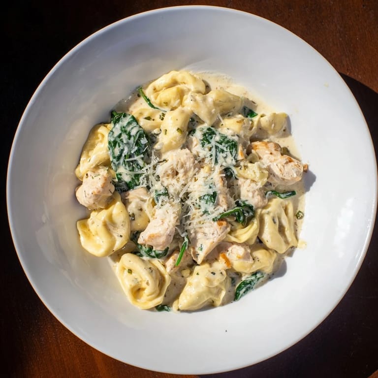 Tender chicken and spinach embrace cheese tortellini in a rich Creamy Chicken and Spinach Tortellini sauce.