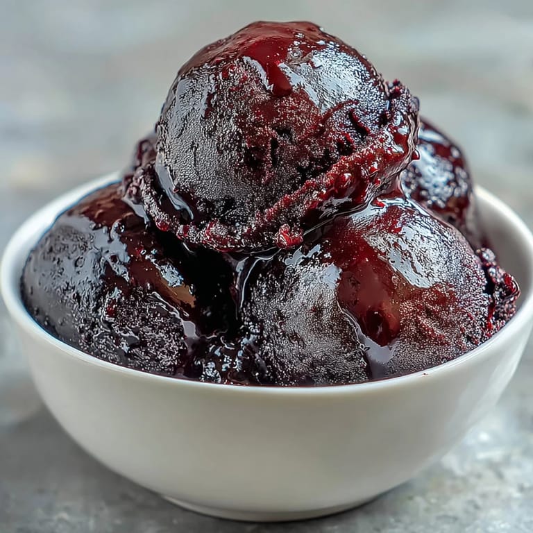 Creamy vegan black currant sorbet made with fresh berries, sugar, and lemon juice for a refreshing summer dessert.  
