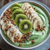 Shamrock Green Smoothie Bowl with Kiwi and Spinach topped with fresh kiwi slices, banana, and crunchy granola for a vibrant, healthy breakfast.