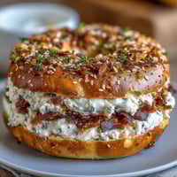 High-protein bagels with Greek yogurt everything dip, golden and chewy, served warm with a creamy, herb-flecked dip.