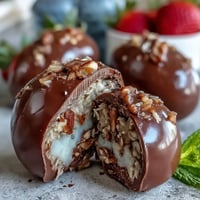 Dubai Chocolate Strawberry Easter Eggs with Crunch Filling, elegantly decorated with edible gold leaf on a festive platter.