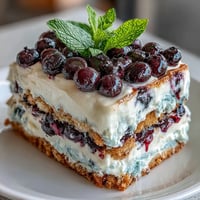Cool, layered Lemon Blueberry Icebox Cake with vibrant berry swirls.